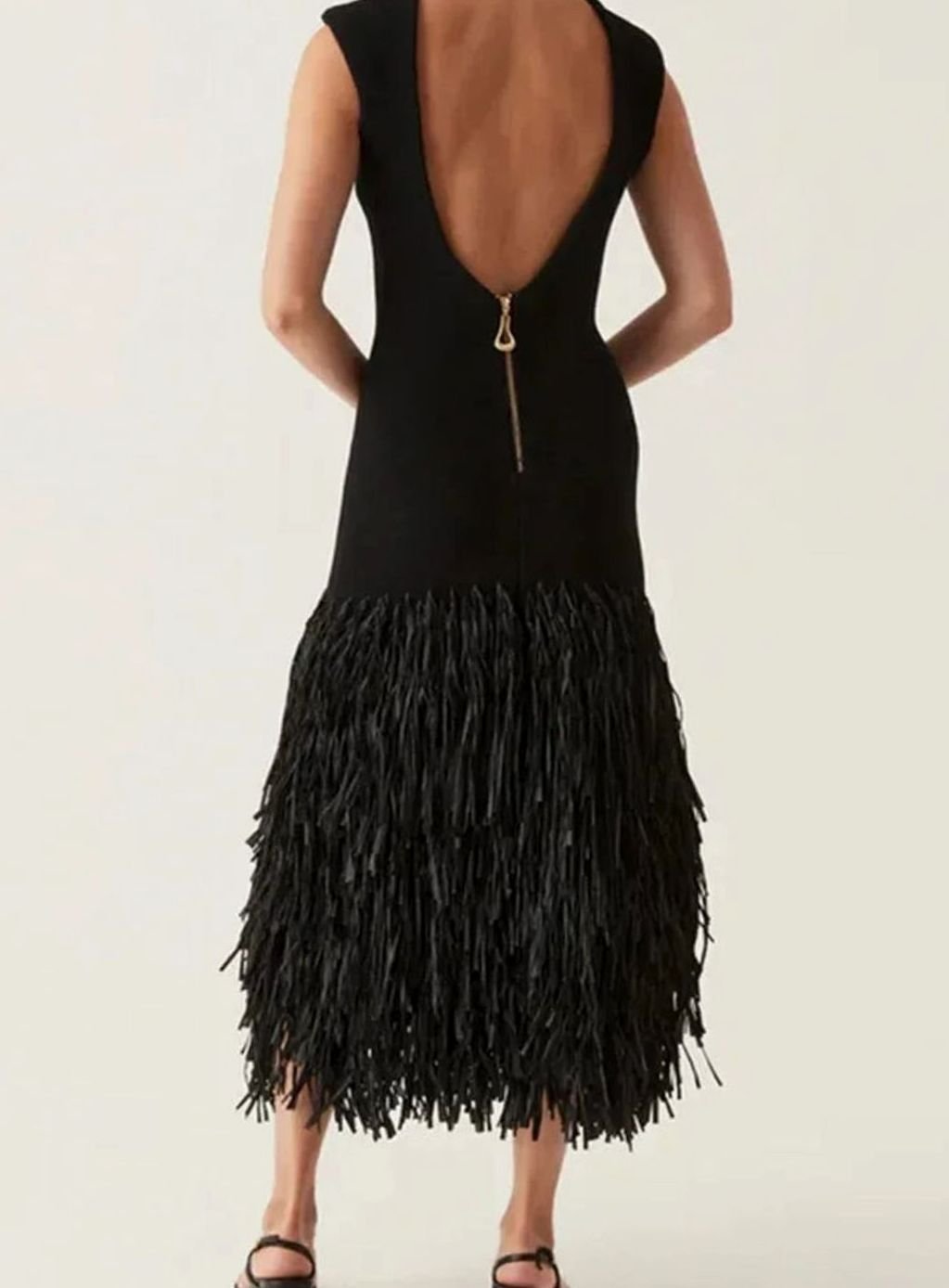 Fashionable women's black midi cocktail dress with a stylish fringe hem, elegant party & evening wear.