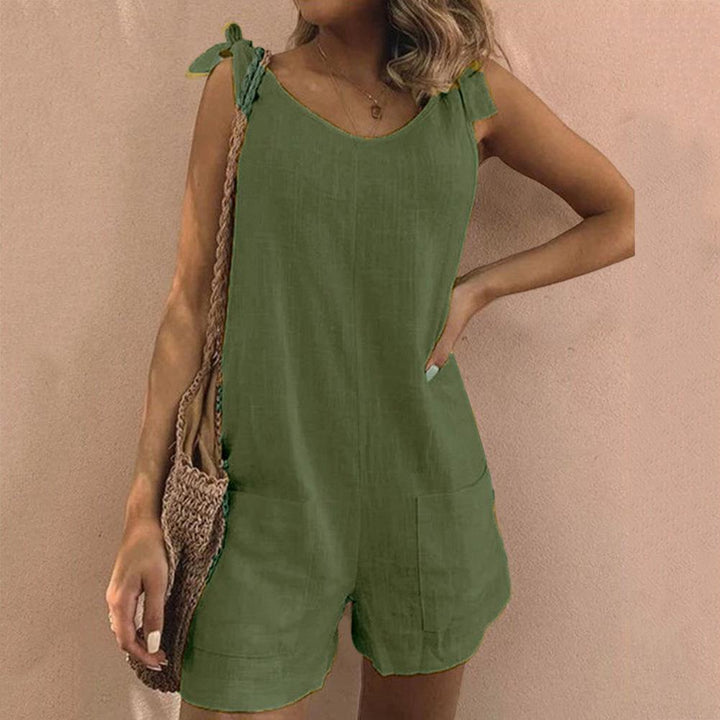 Elegant women's sleeveless romper with playful bow straps and pockets, a versatile and comfortable summer piece.