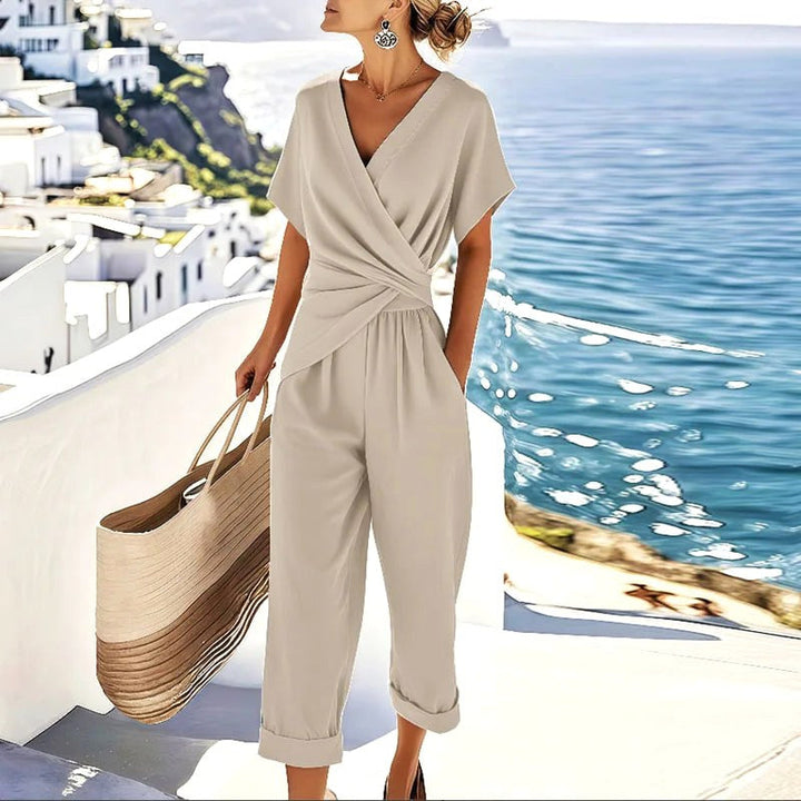 Women's elegant apricot wrap two-piece set with tailored trousers, perfect for a chic summer or business casual look.
