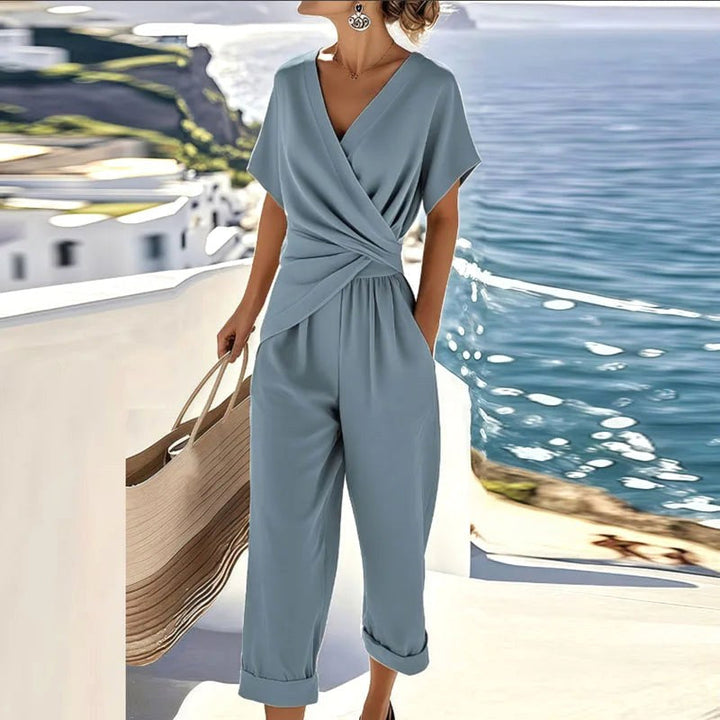 Coordinated women's blue two-piece set featuring a stylish wrap top and comfortable tailored trousers for summer.