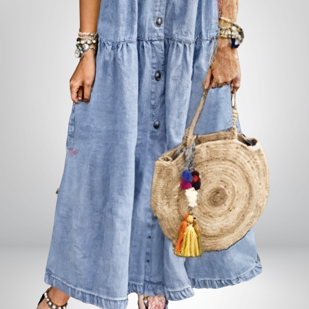 Stylish blue denim dress for women, featuring a button-front bodice and a fashionable tiered midi skirt.