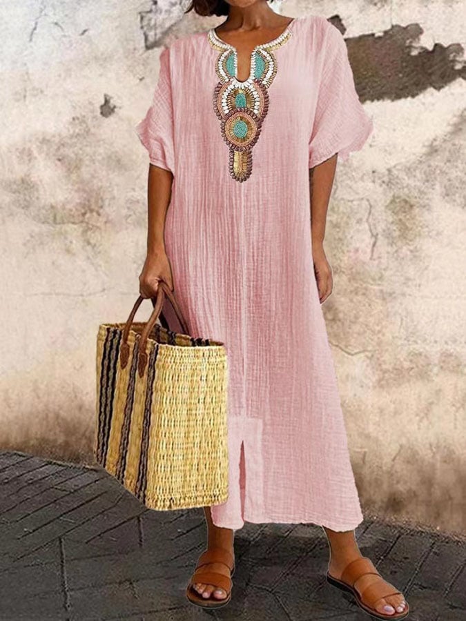 Elegant women's embroidered maxi dress with a V-neck, embodying classic boho style for warm weather.