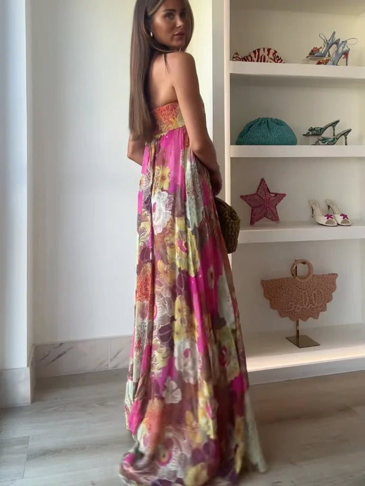 Elegant women's strapless maxi dress with vibrant floral print, suitable for sophisticated gatherings.