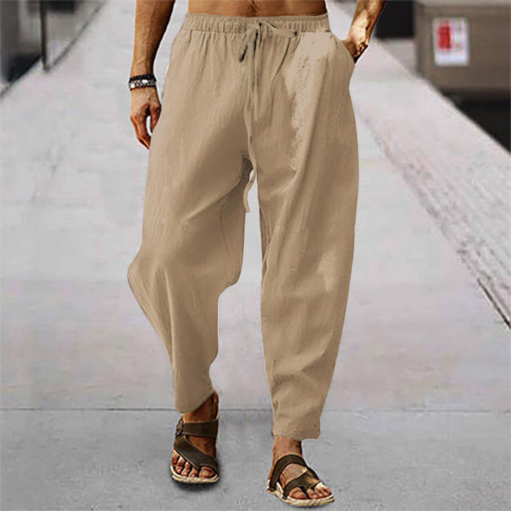 Man models comfortable men's relaxed fit drawstring pants, showcasing their casual and everyday appeal.