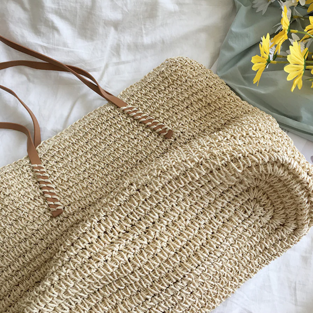 Women's spacious shoulder bag with sturdy strap and stylish woven design for daily errands.