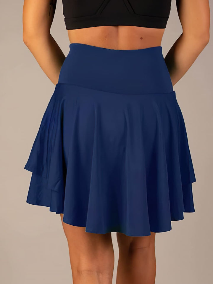 Sporty women's skort for tennis, golf, or fitness. Features quick-dry fabric & convenient side pockets.