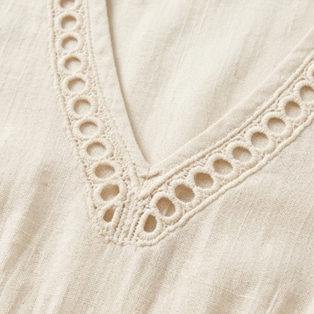 Close-up of the delicate crochet trim on the V-neck of a chic women's midi dress.