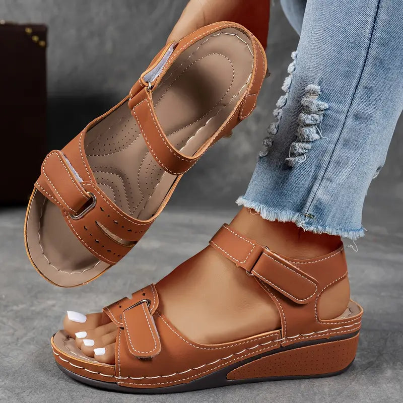 Stylish women's open-toe wedge sandals with ankle strap, perfect orthopedic footwear for summer casual outfits.
