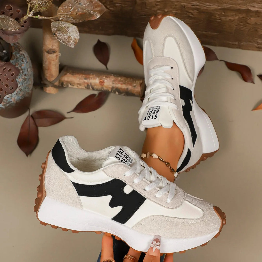Stylish women's striped platform sneakers with lace-up detail, offering comfort and trendy appeal for casual wear.