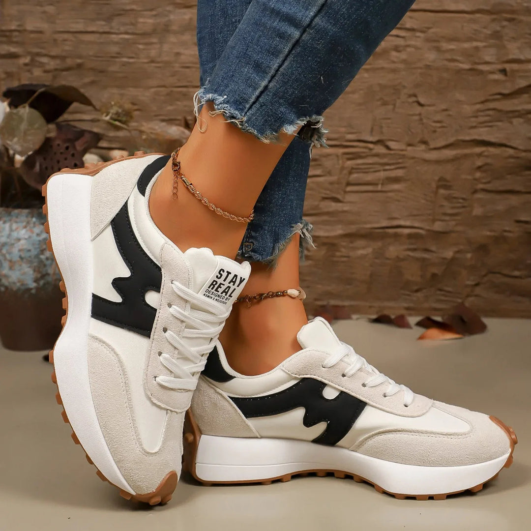 Fashion-forward women's striped platform sneakers, boosting height & style for a casual yet elevated outfit.
