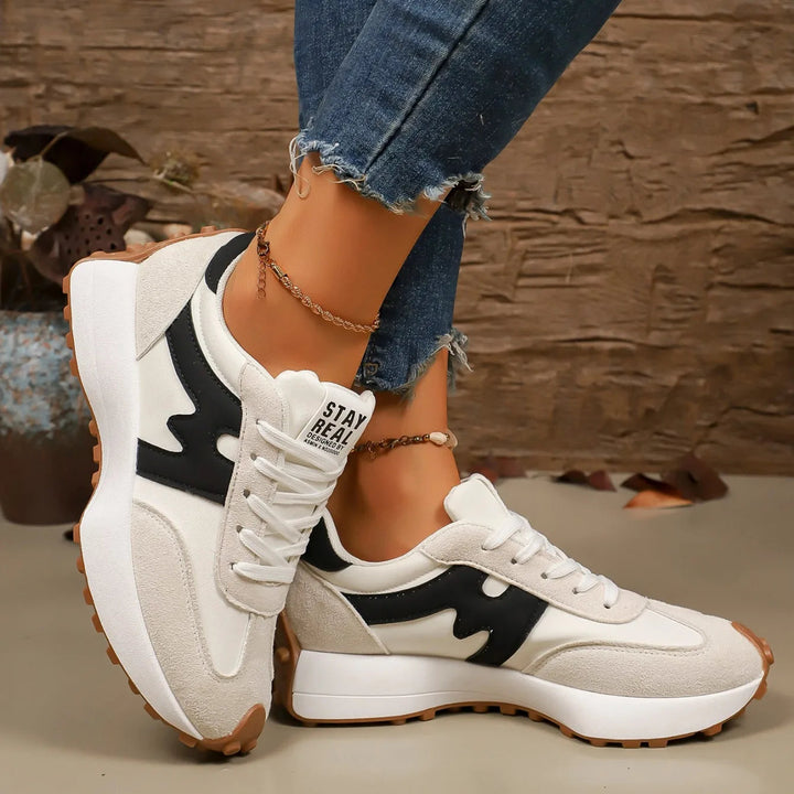 Fashion-forward women's striped platform sneakers, boosting height & style for a casual yet elevated outfit.