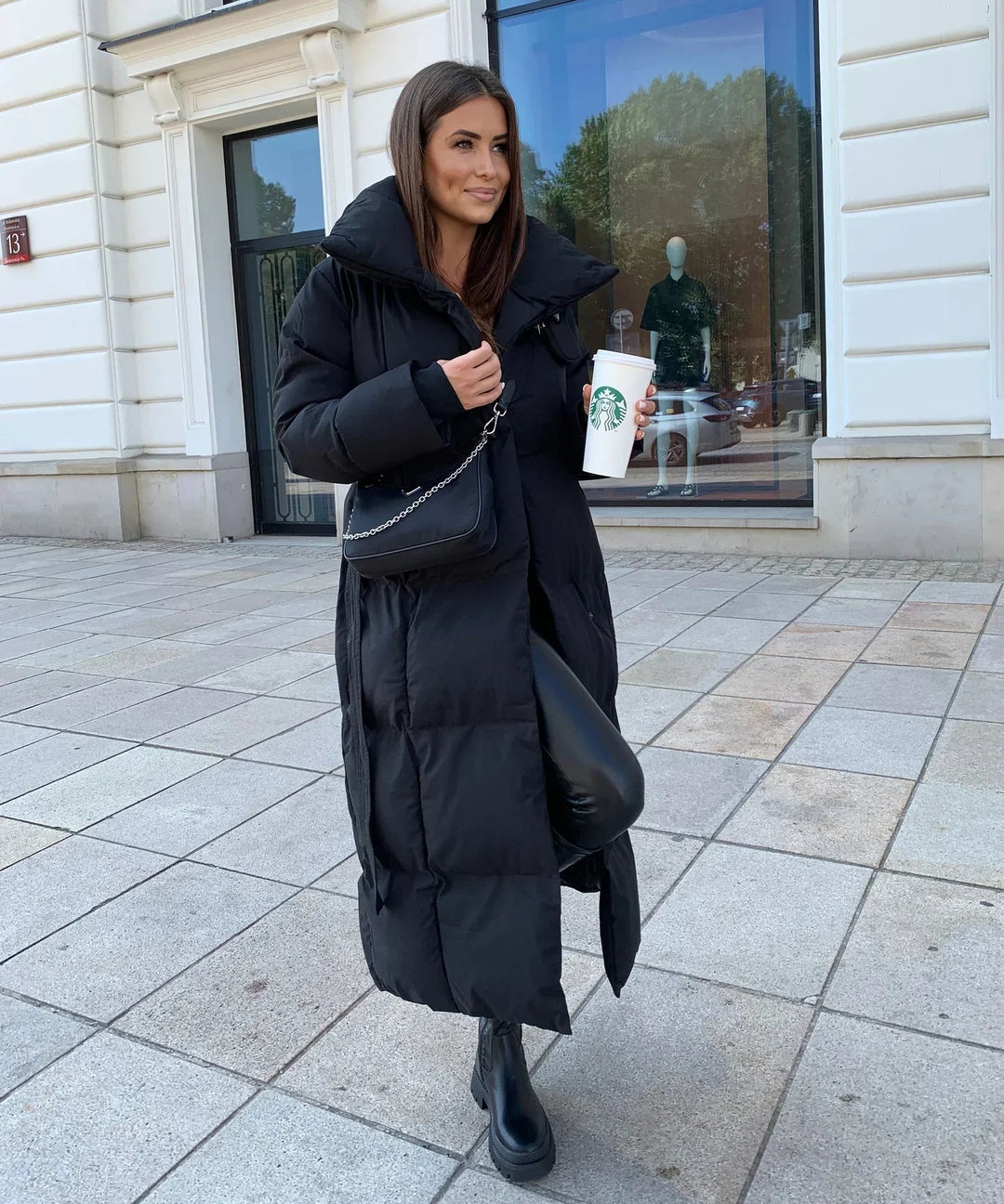 Stylish black women's long puffer jacket, perfect cozy winter outerwear for cold weather fashion.
