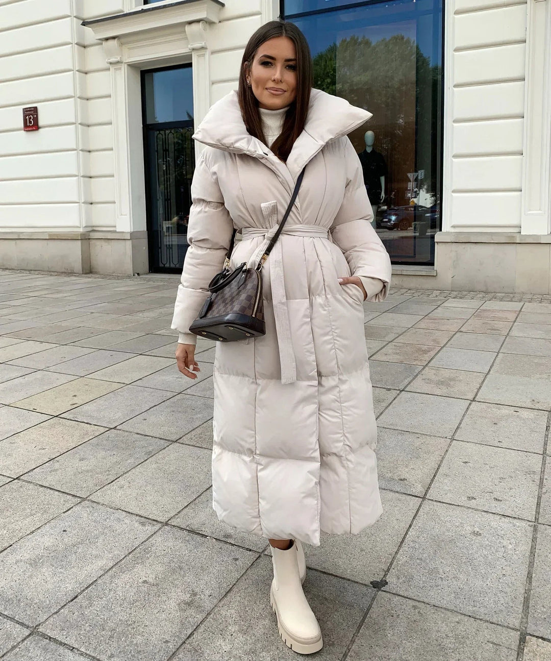Cozy grey women's puffer jacket, a warm long winter coat designed for stylish cold weather outerwear.