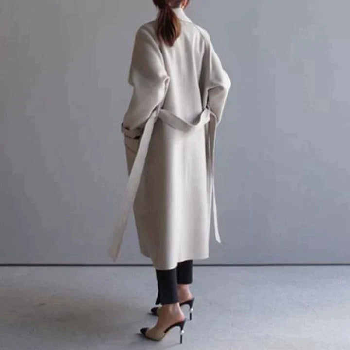 Elegant women's long winter coat in a warm fabric, perfect for stylish cold-weather layering.