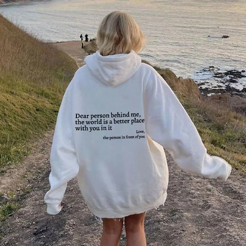 Women's Aurora "Spread Positivity" hoodie. Comfortable, stylish long-sleeve casual wear, inspiring message.