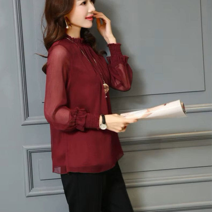 Stylish women's blouse with statement sheer puff sleeves & subtle ruffles, a feminine top for any occasion.