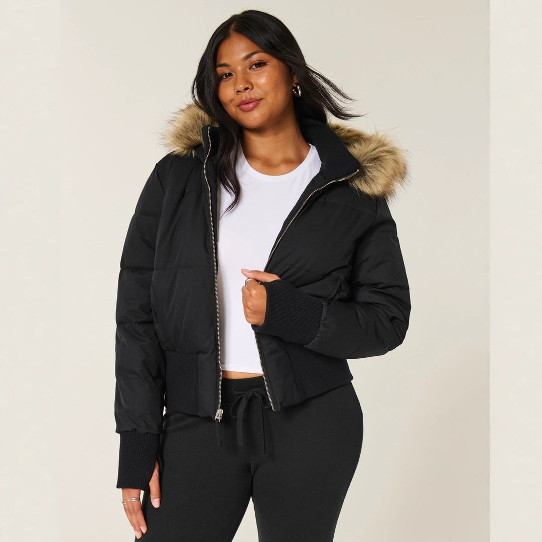 Fashionable black hooded jacket for women, designed with warm quilting for ultimate winter comfort.