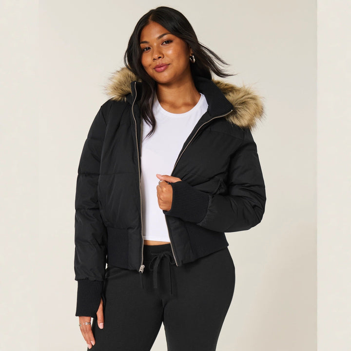 Fashionable black hooded jacket for women, designed with warm quilting for ultimate winter comfort.