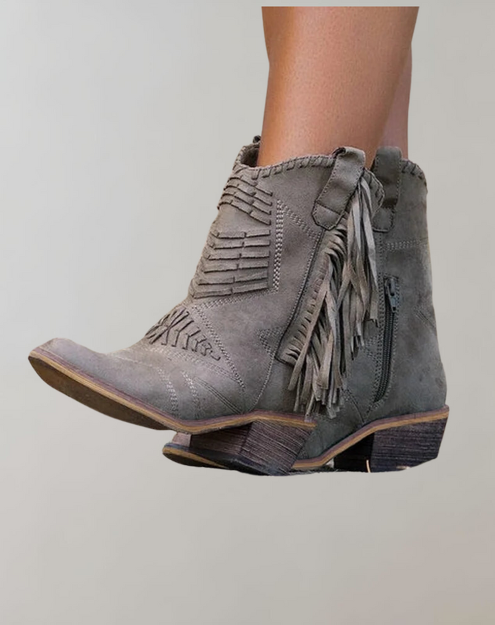 Stylish women's tasseled ankle boots in black, perfect for fall and winter fashion. Chic and comfortable everyday footwear.