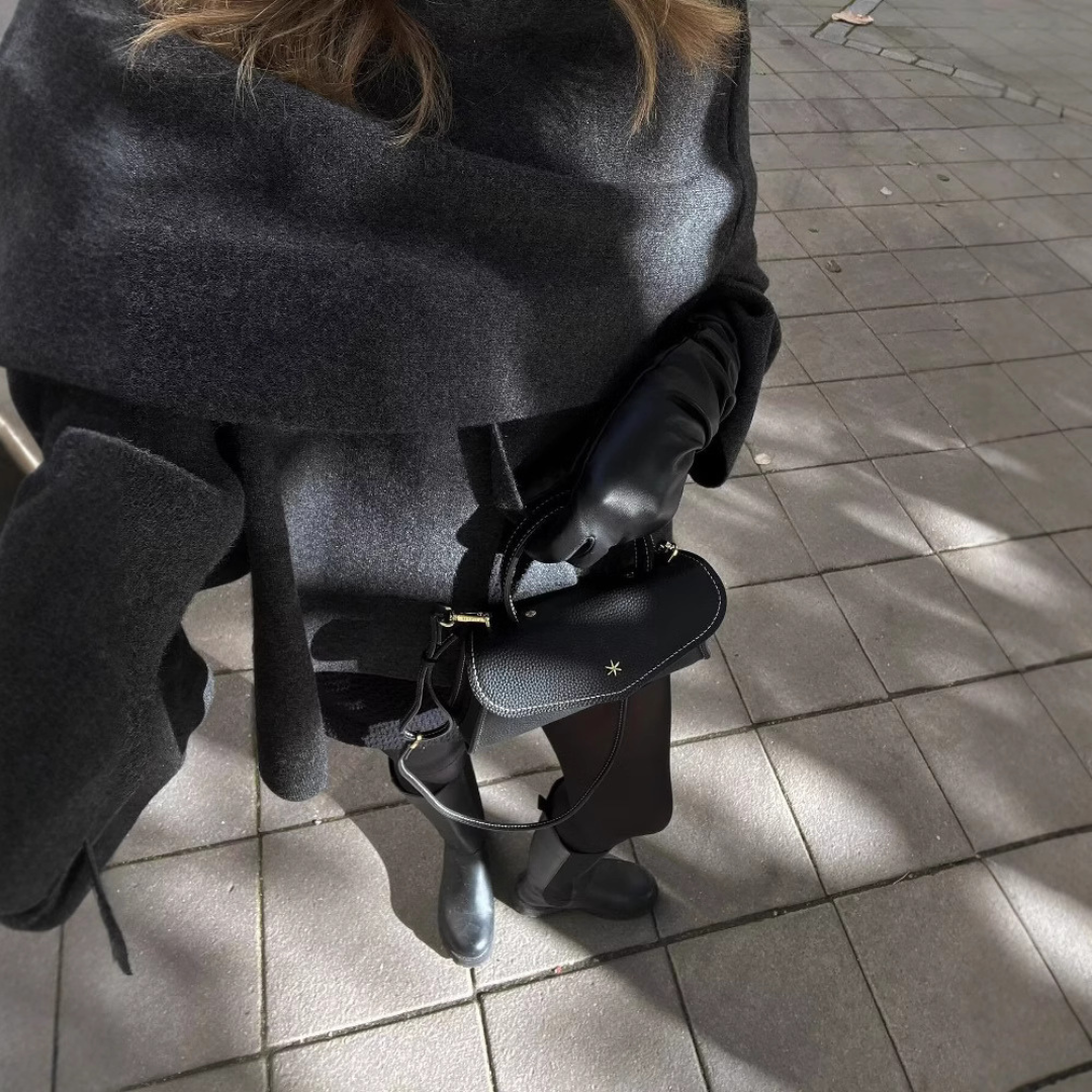 Oversized asymmetrical winter poncho for women, offering a comfortable and chic layered look.