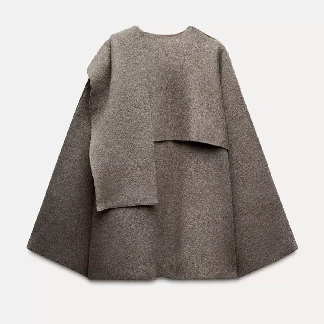 Soft grey women's asymmetrical poncho, cozy outerwear for a comfortable and stylish winter look.