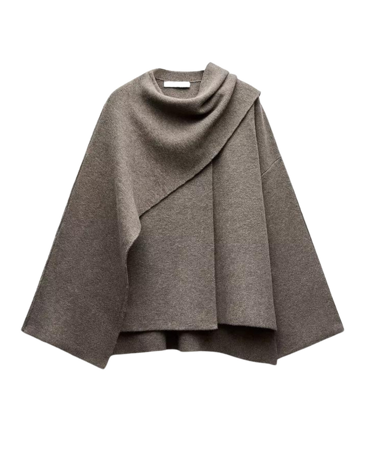 Stylish women's asymmetrical winter poncho, perfect for a cozy, layered fall fashion look.