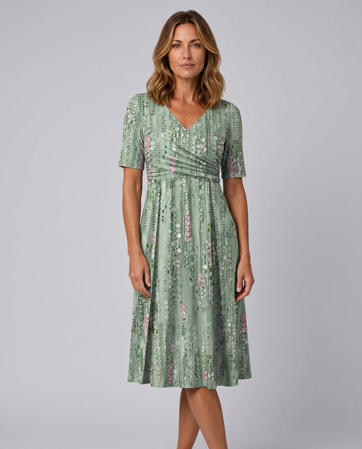 Chic women's green faux wrap A-line midi dress with V-neck and flared skirt, perfect for summer casual elegance.