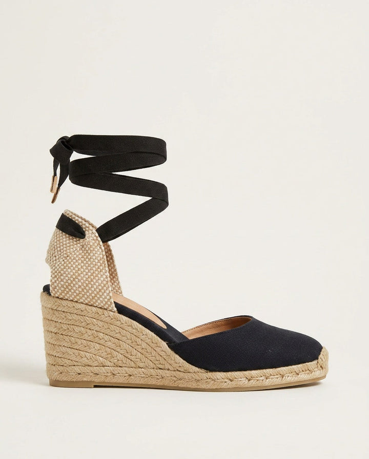 Elegant women's espadrille wedge sandals with ankle-tie, perfect vacation footwear for summer.