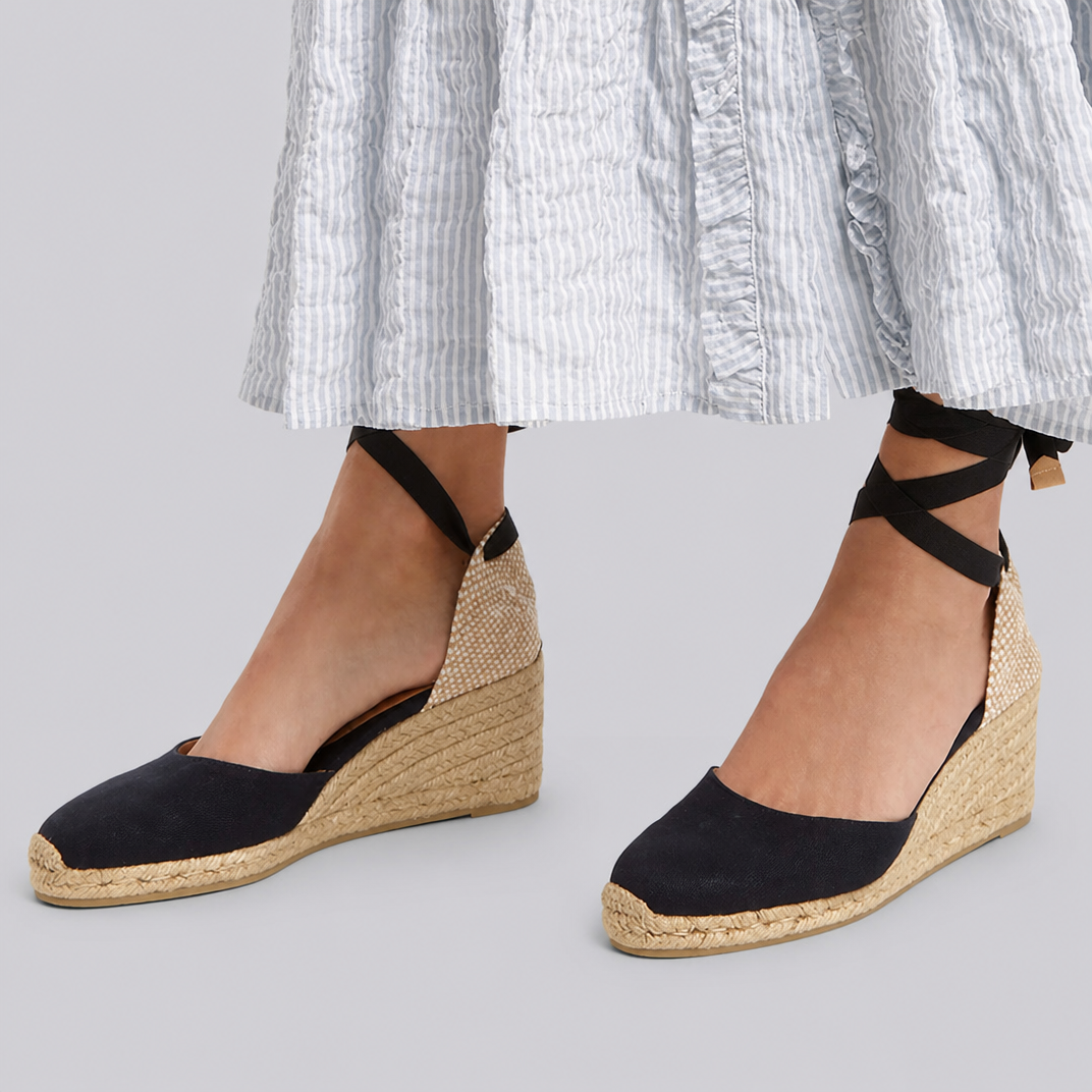 Red ankle-tie espadrille wedge sandals for women, stylish closed-toe summer vacation footwear.