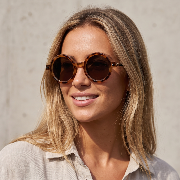 Classic round vintage style sunglasses with tinted lenses, a unisex fashion accessory.