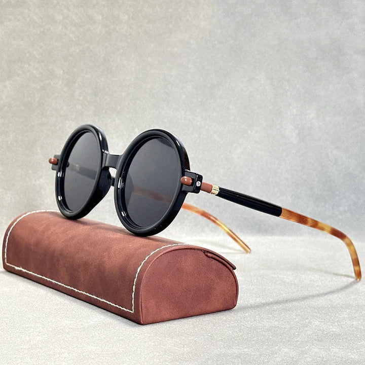 Elegant unisex round sunglasses with dark tinted lenses, embodying vintage fashion.