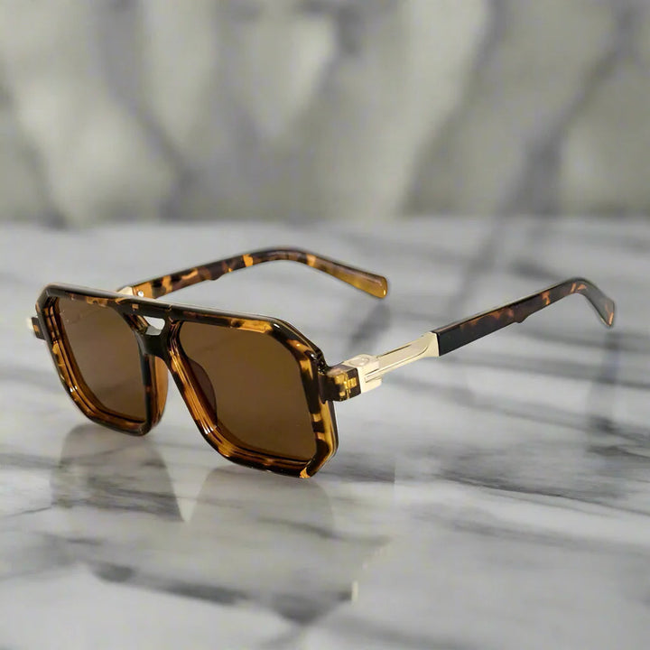 Close-up of modern square aviator sunglasses with dark UV400 lenses. Unisex fashion eyewear accessory.