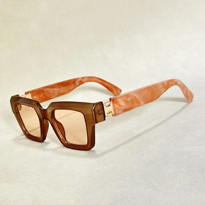 Modern retro chunky square frame sunglasses with elegant marble-effect arms; unisex eyewear choice.