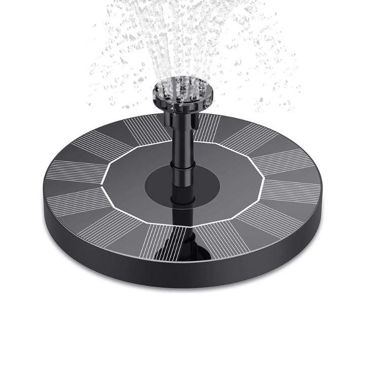 Floating solar water fountain operating in a garden pond, creating a beautiful water feature for birds and decor.