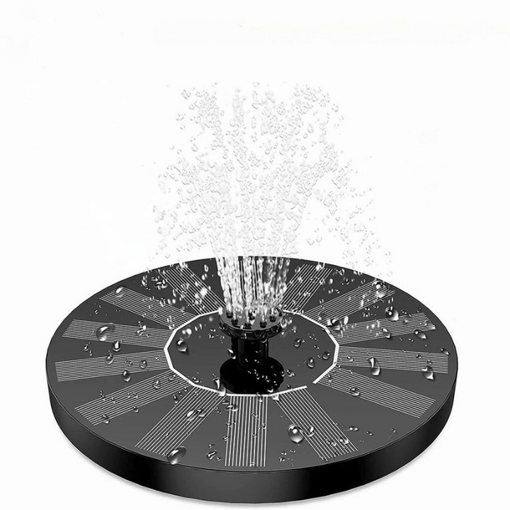 Solar bird bath fountain kit floating in a ceramic bird bath, providing a soothing water feature for garden wildlife.