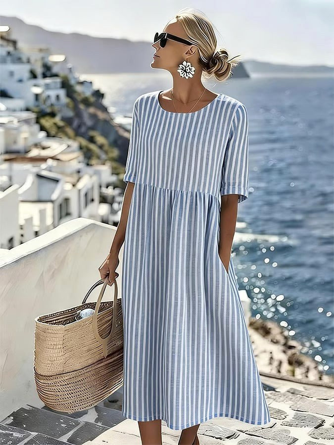 Women's blue flowing striped midi dress. Relaxed fit, perfect for comfortable summer days, vacation, or casual wear.