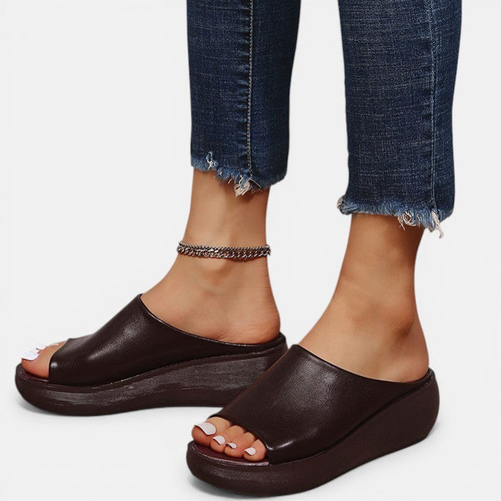 Woman walking comfortably in Tahnee orthopaedic slip-on sandals, showcasing support & pain relief.