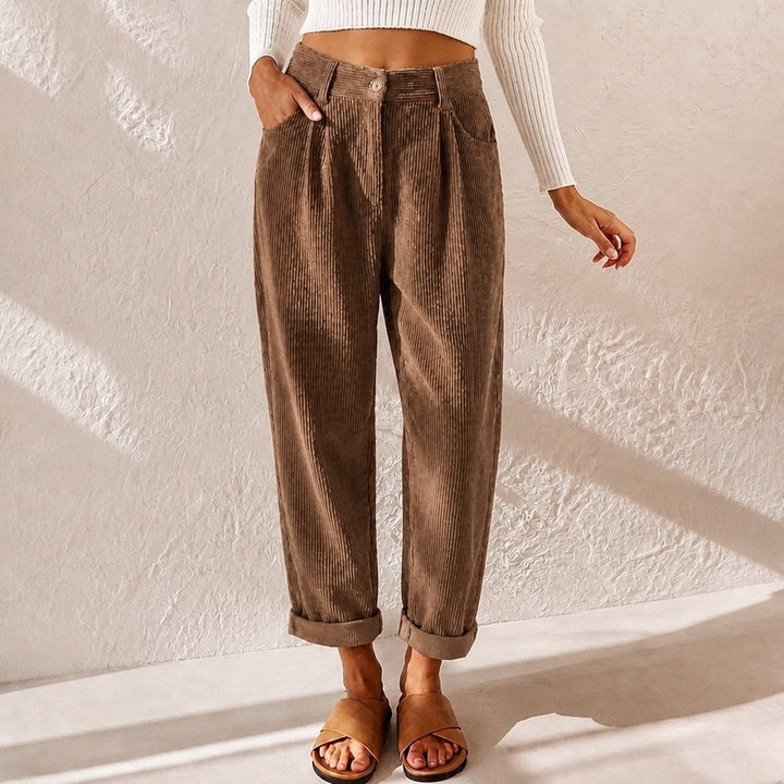Stylish pleated high-waist women's pants with a wide-leg silhouette, perfect for a flowy look.