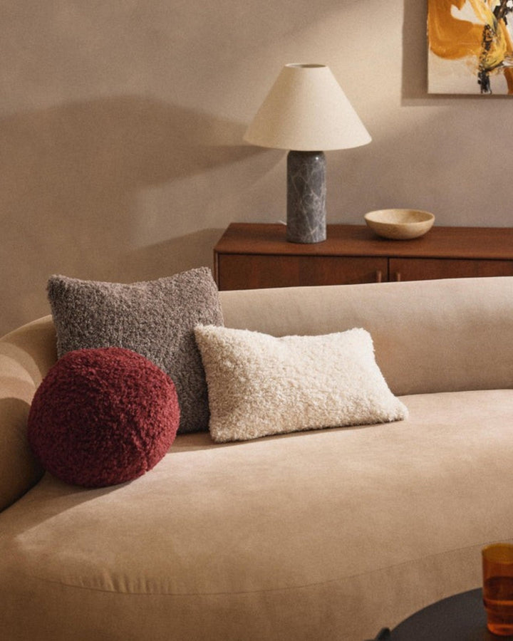 Comfortable fluffy pillow cover in taupe plush, a cozy addition to any home decor setting.