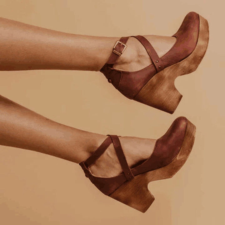Stylish women's closed-toe wedge heels with secure ankle strap, ideal for formal events or casual summer wear.