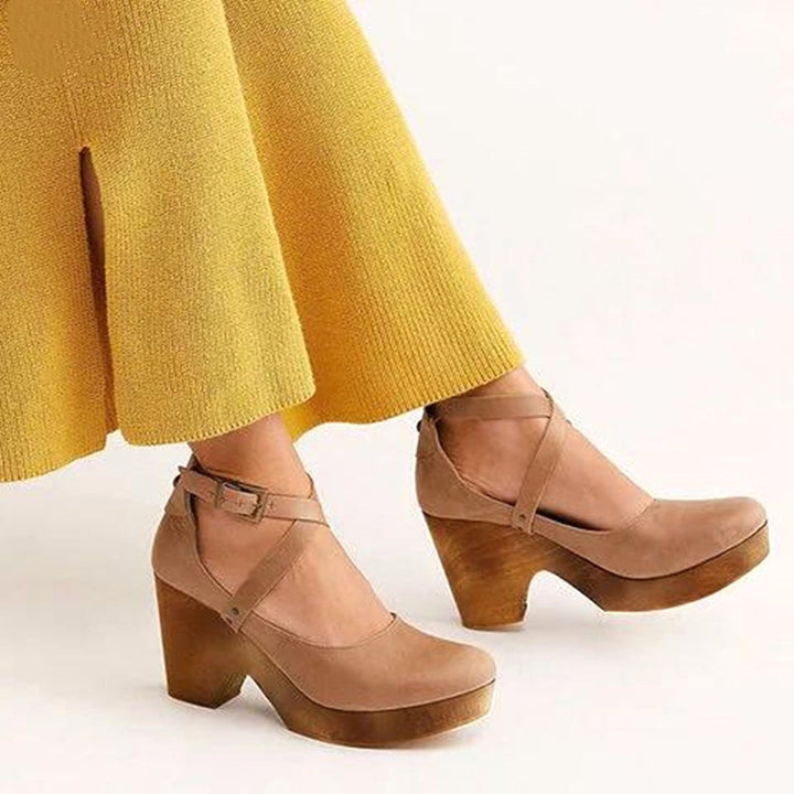 Fashionable women's closed-toe wedge shoes with an adjustable ankle strap, offering stability and comfort.