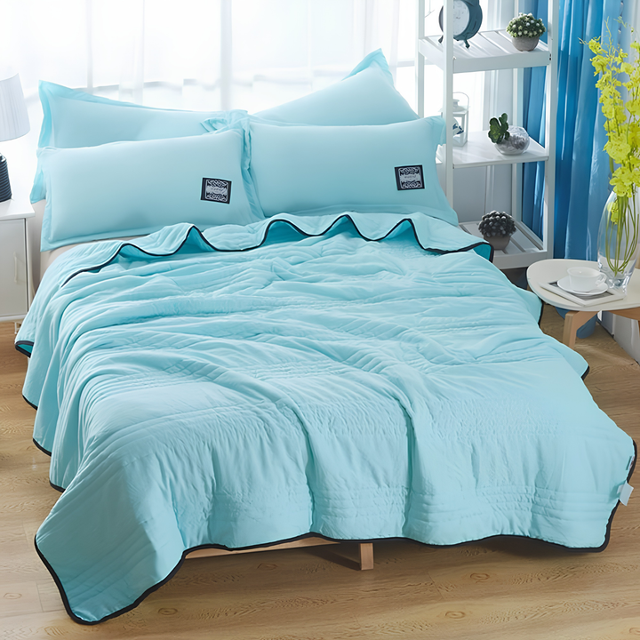 Soft, comfortable ultra-cooling blanket in a neutral tone, designed for night sweats and summer heat relief.