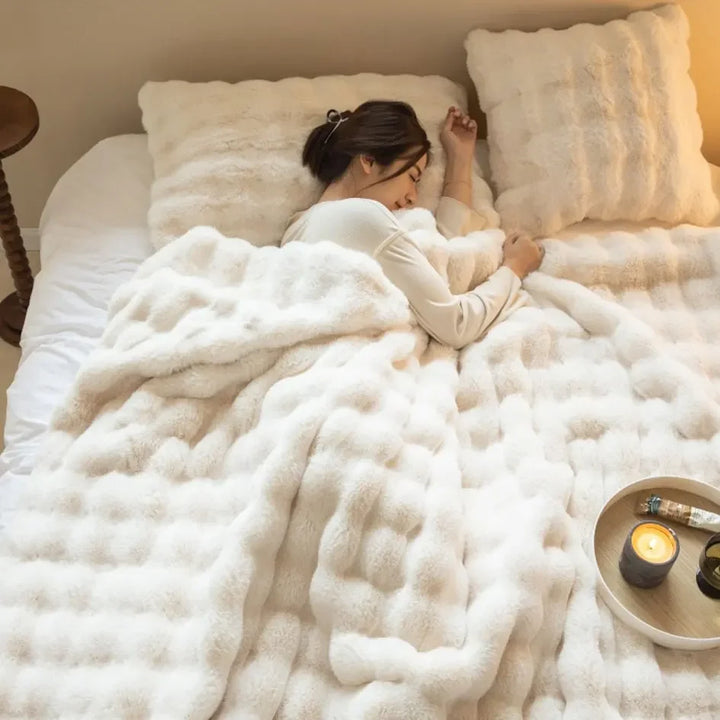 Cozy plush throw blanket, a soft & warm comfort gift. Enhances bedroom or living room decor.