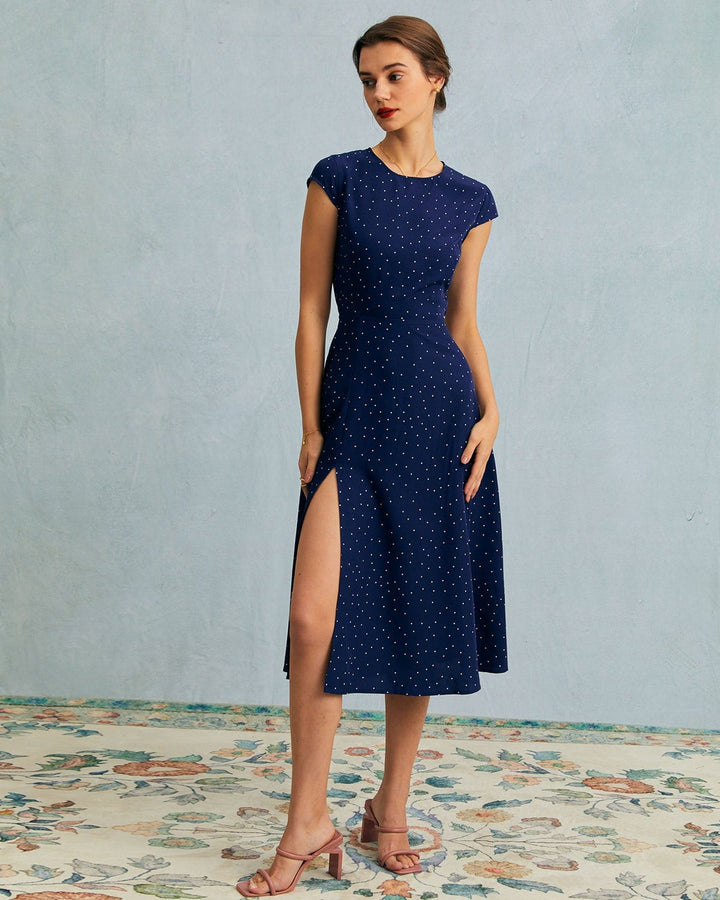 Cute women's polka dot midi dress in navy blue with a fashionable cut-out detail, great for casual summer wear.