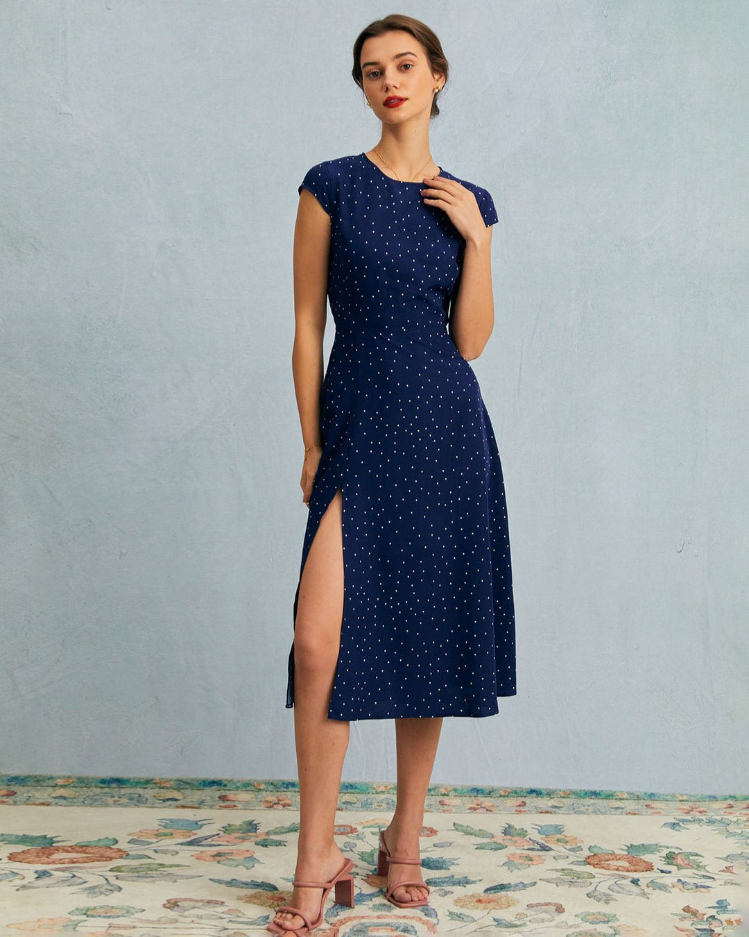 Women's navy blue polka dot midi dress with chic cut-out details and cap sleeves. Perfect for summer & office.