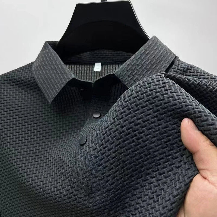 Man wearing a comfortable textured short sleeve polo shirt, perfect for active casual wear.