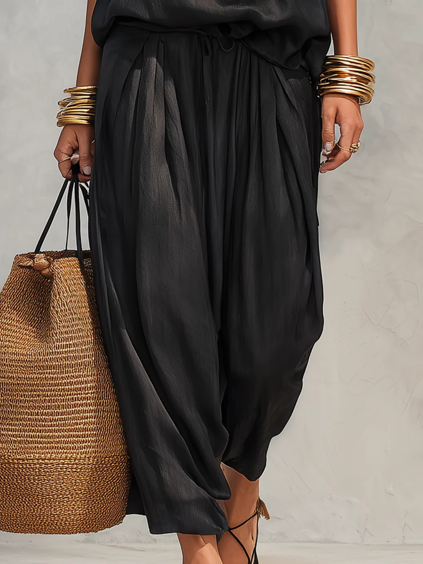 Modern women's elegant two-piece set with a sophisticated cowl neck halter and flattering wide-leg pants.
