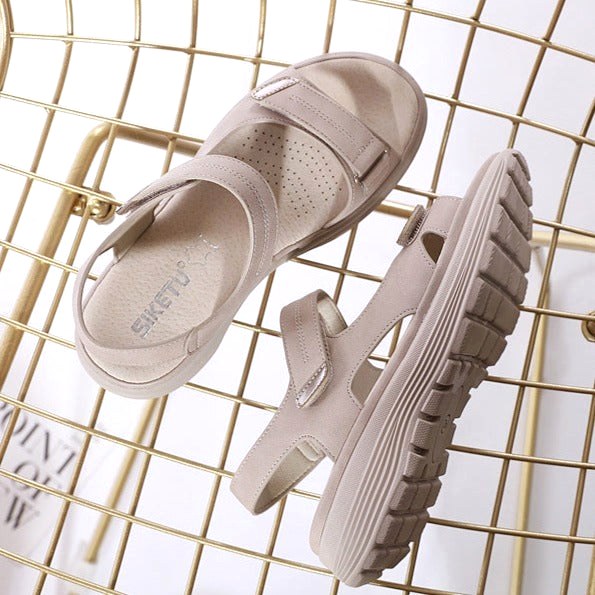 Stylish women's supportive sandals with flat straps, providing orthopedic arch support for all-day comfort.