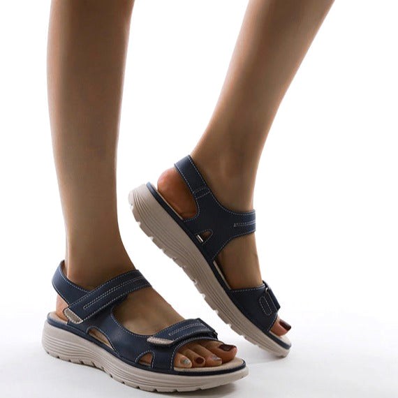 Close-up of women's orthopedic flat strap sandals, highlighting arch support for superior comfort & stability.