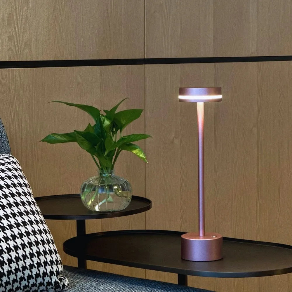 Aluminum modern table lamp, dimmable and cordless, adding elegant ambient lighting.